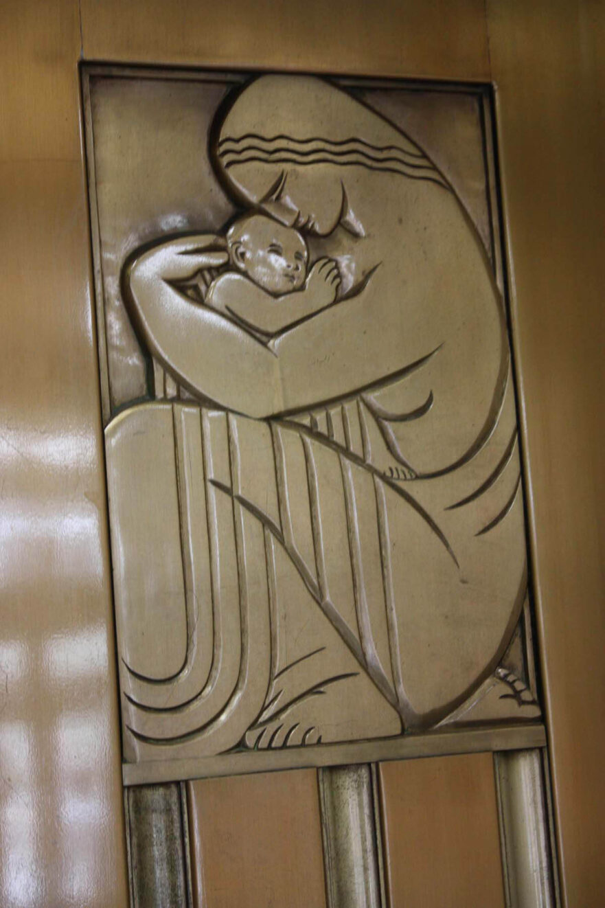 10 Close up of the figure on the right elevator door in the main lobby.