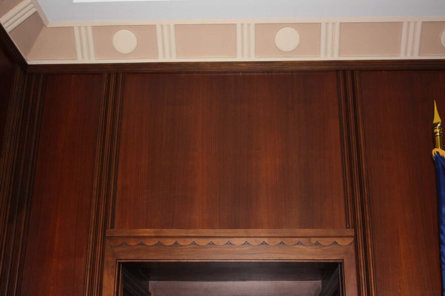 19 Fluted wall wood paneling and scalloped detail over door frame in Mayor’s conference room.