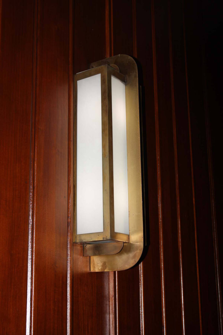 29 Original brass and glass wall sconce in the courtroom.