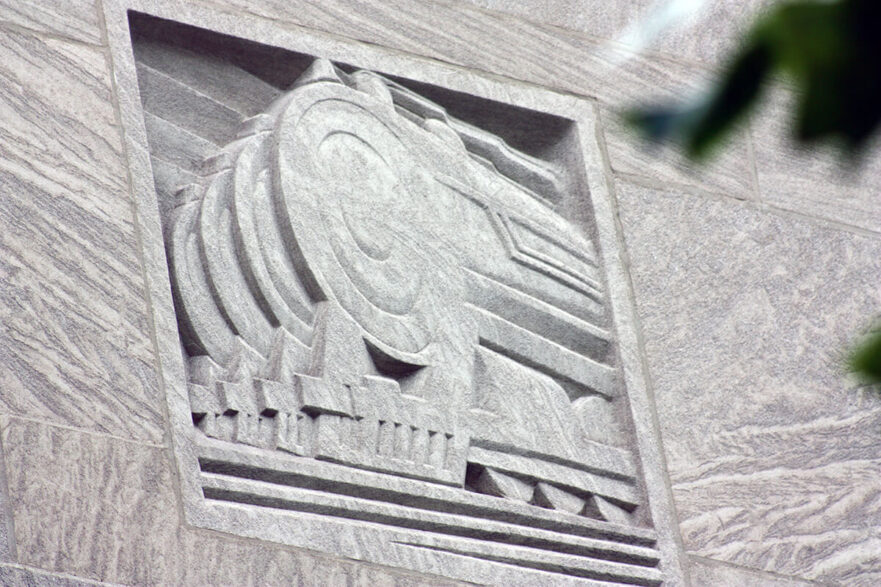 37 Carving on the upper area of the north and south extensions of City Hall, this is an Art Deco representation of trains, circa 2022.