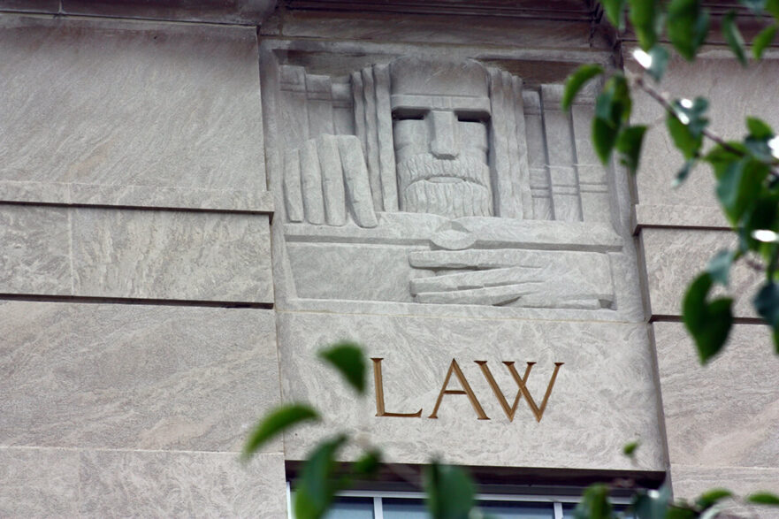 43 West façade, north corner, note the Art Deco carving of Law, circa 2022.