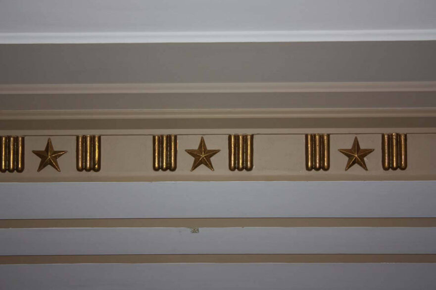 6 Plaster ceiling molding in main floor lobby has a design of 3 rods, a star and 3 rods.